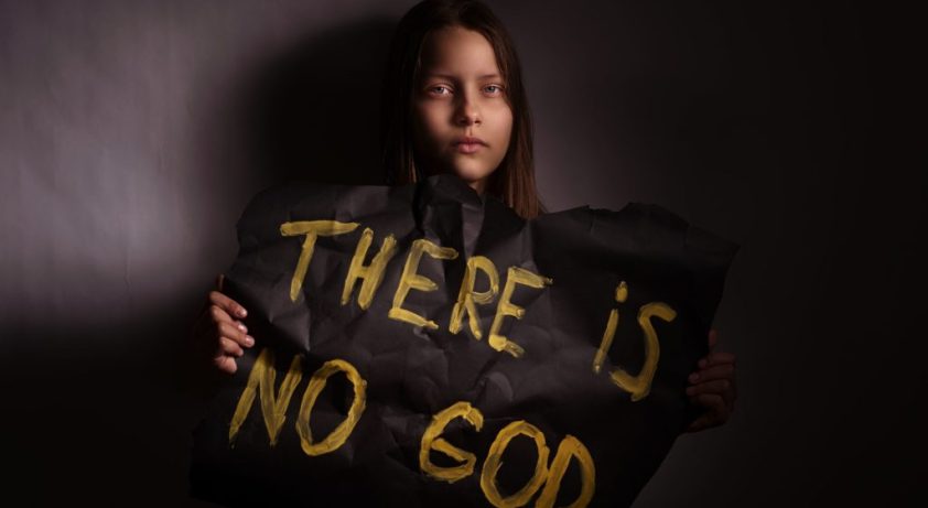 31377387 - atheist teen girl holding a banner with the inscription-"there is no god"